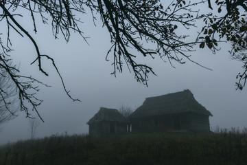 Landscape with alone old house on foggy meadow. Can be used like Halloween background. Located...