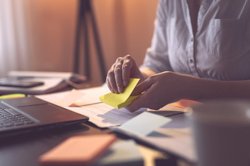 Business woman using sticky notes