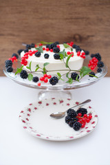 A summer dessert of Cheesecake with berries and mint