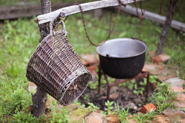 Wooden basket and a cast iron cauldron