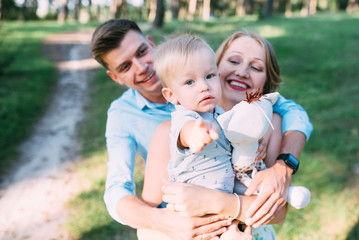 A cute family - mom, dad and son spend fun time in nature