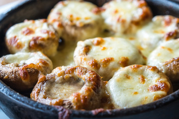 Stuffed mushrooms with cheese on the pot, Georgian cuisene