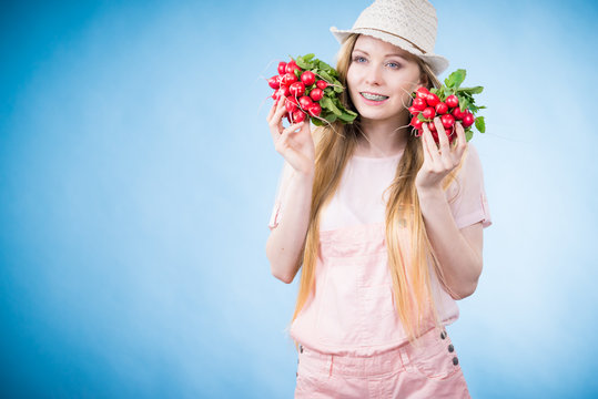 Young woman holding radish