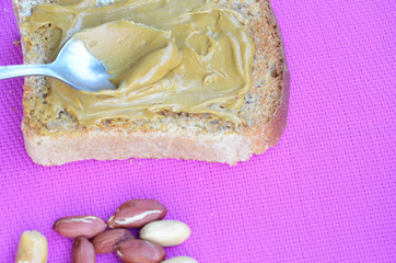Peanut butter sandwiches or toasts on purple background