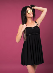 Happy young brunette woman in a black dress