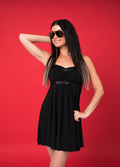 Happy young brunette woman in a black dress