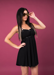 Happy young brunette woman in a black dress