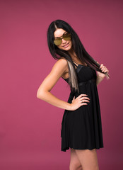 Happy young brunette woman in a black dress