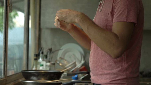 Young man taking photo of food while cooking meal in kitchen 
