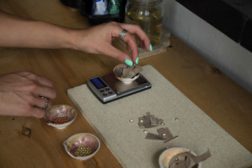 The process of making silver jewellery. Female artist hands close up. Crafting a silver ring, see the entire series.