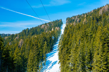 Amazing winter ski resort mountain view with skiing slopes and mighty mountains.