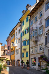 Street in Bolzano with traditional typical antique houses - obrazy, fototapety, plakaty