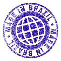 MADE IN BRAZIL stamp print with distress texture. Blue vector rubber seal print of MADE IN BRAZIL tag with retro texture. Seal has words arranged by circle and planet symbol.