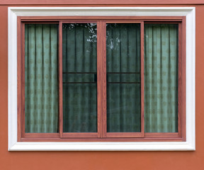 Brown wood patterned window with concrete wall.
