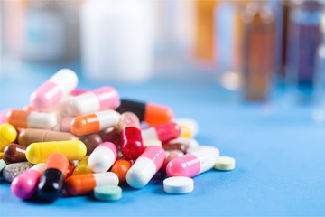 Colorful pills and tablets on background