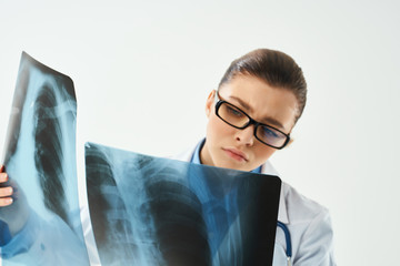 doctor with glasses looking at x-ray medicine