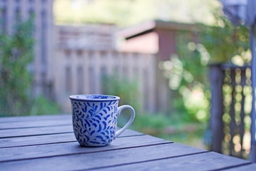 Mug in blue pattern on wooden table