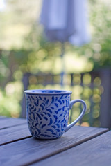 Mug in blue pattern on wooden table