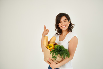smiling woman holding a grocery bag