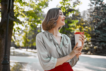 woman with coffee in the street