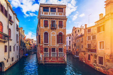 View of the street canal in Venice, Italy. Colorful facades of old Venice houses. Venice is a popular tourist destination of Europe. Venice, Italy.