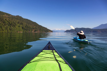 Kayaking in Harrison Lake during a beautiful and vibrant summer day. Located East of Vancouver,...