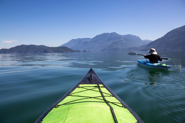 Kayaking in Harrison Lake during a beautiful and vibrant summer day. Located East of Vancouver, British Columbia, Canada.