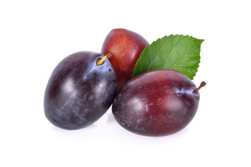 whole fresh prunes with leaf on white background