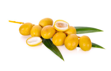 bunch of fresh yellow dates with leaf on white background