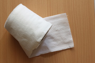 toilet paper on the wooden texture background, copy space.