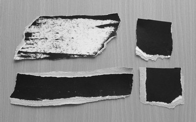 black torn paper texture on wood background, copy space.