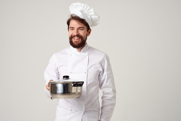 chef smiling holding pan