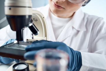 female lab technician with microscope