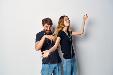 man and women listening to music on headphones