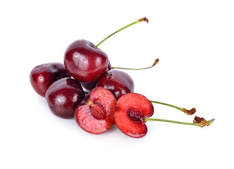 whole and half cut fresh cherry with stem on white background