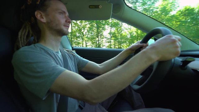 Person driving an electric vehicle on a bright afternoon