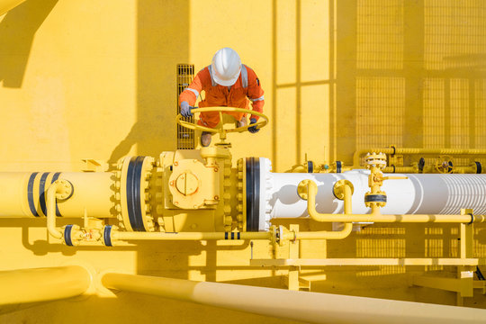 Offshore oil and gas site service operator open valve for control gases and crude product, Petroleum and chemical industry business.