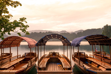 Touring boats at sunset on famous Lake Bled, Slovenia