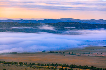 Mountainous landscape with low clouds on early morning