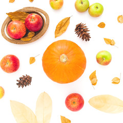 Thanksgiving autumn background made of fall dried leaves, pine cones, apples and pumpkin on white background. Flat lay, top view
