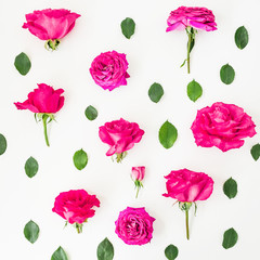 Creative floral pattern of pink rose flowers and leaves on white background. Flat lay, Top view.