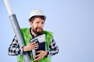 builder in a helmet with drawings documents architecture