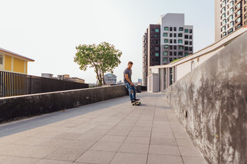 Young man riding skateboard on the street.