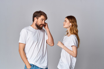 young couple in white t-shirts look at each other