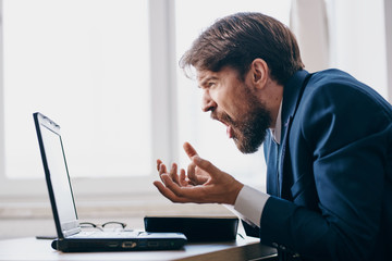 business man shouting a laptop