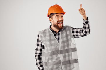 a builder in a helmet shouts