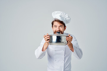 cook prepares food in the hands of the pan