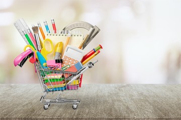 Variety office supplies in little shopping cart