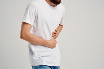 A man holding his stomach in pain logo