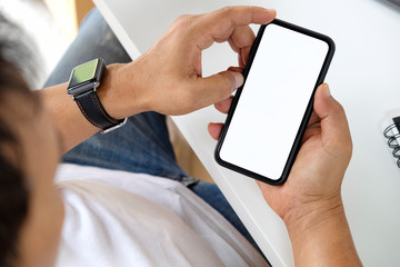Mockup of mobile phone with blank copy space screen in male hand.